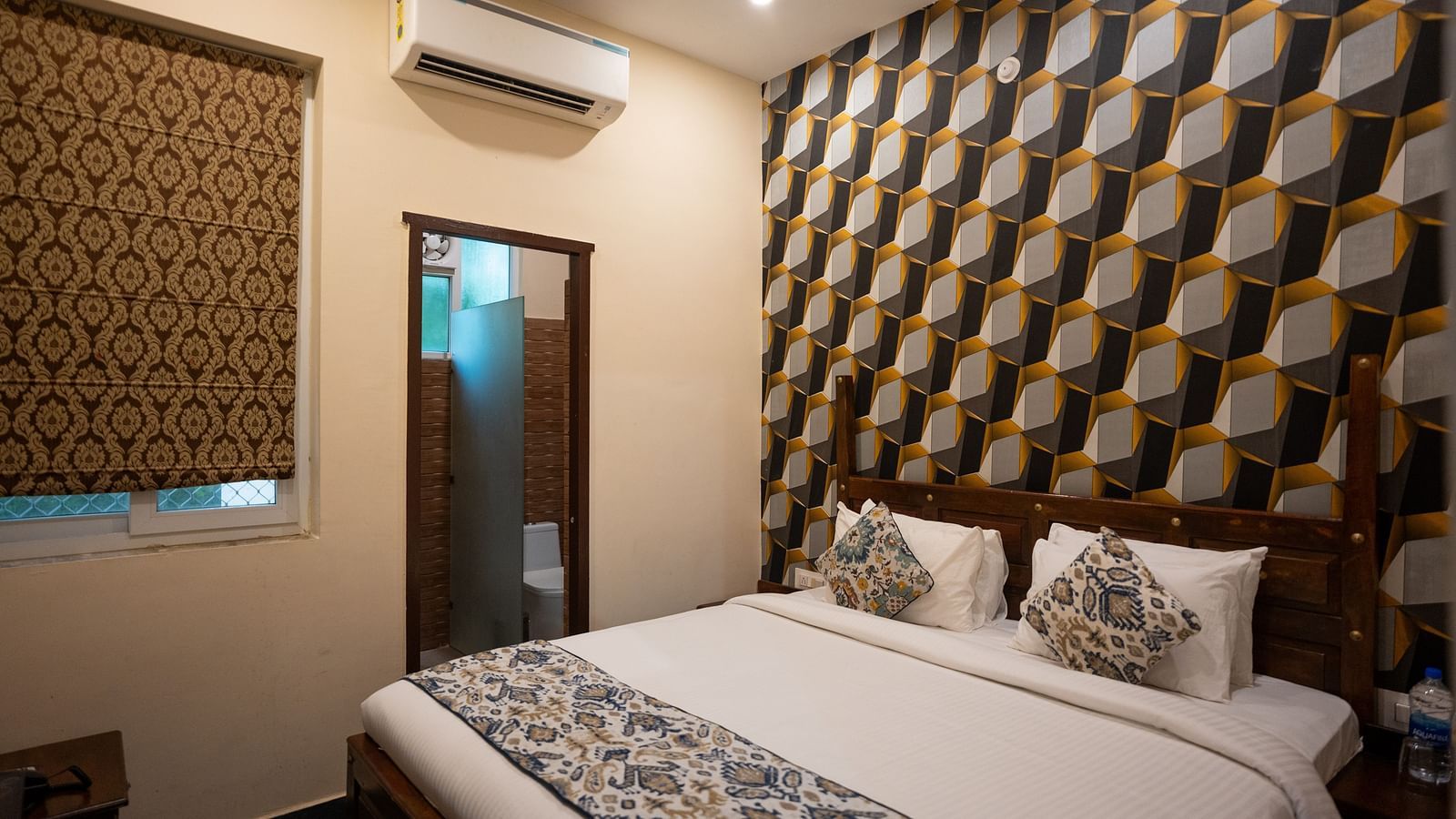 Image of a room with bed and a door on the side at Aanandam Resort & Spa, Pushkar.