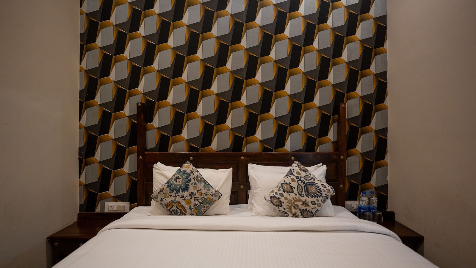 Image of a room with bed and decor on the wall behind the bed at Aanandam Resort & Spa, Pushkar.