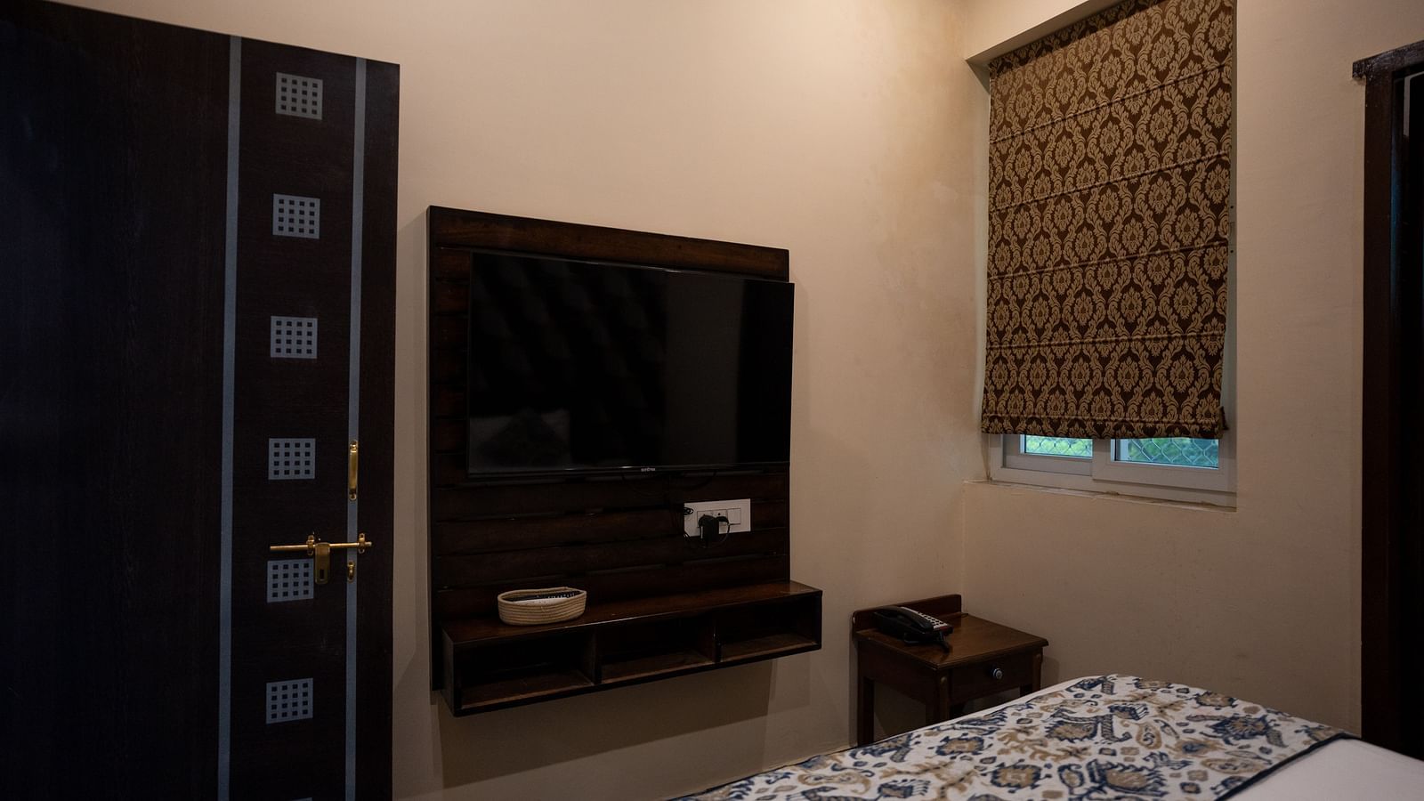 Image of a room with a bed and a television in front of it at Aanandam Resort & Spa, Pushkar.