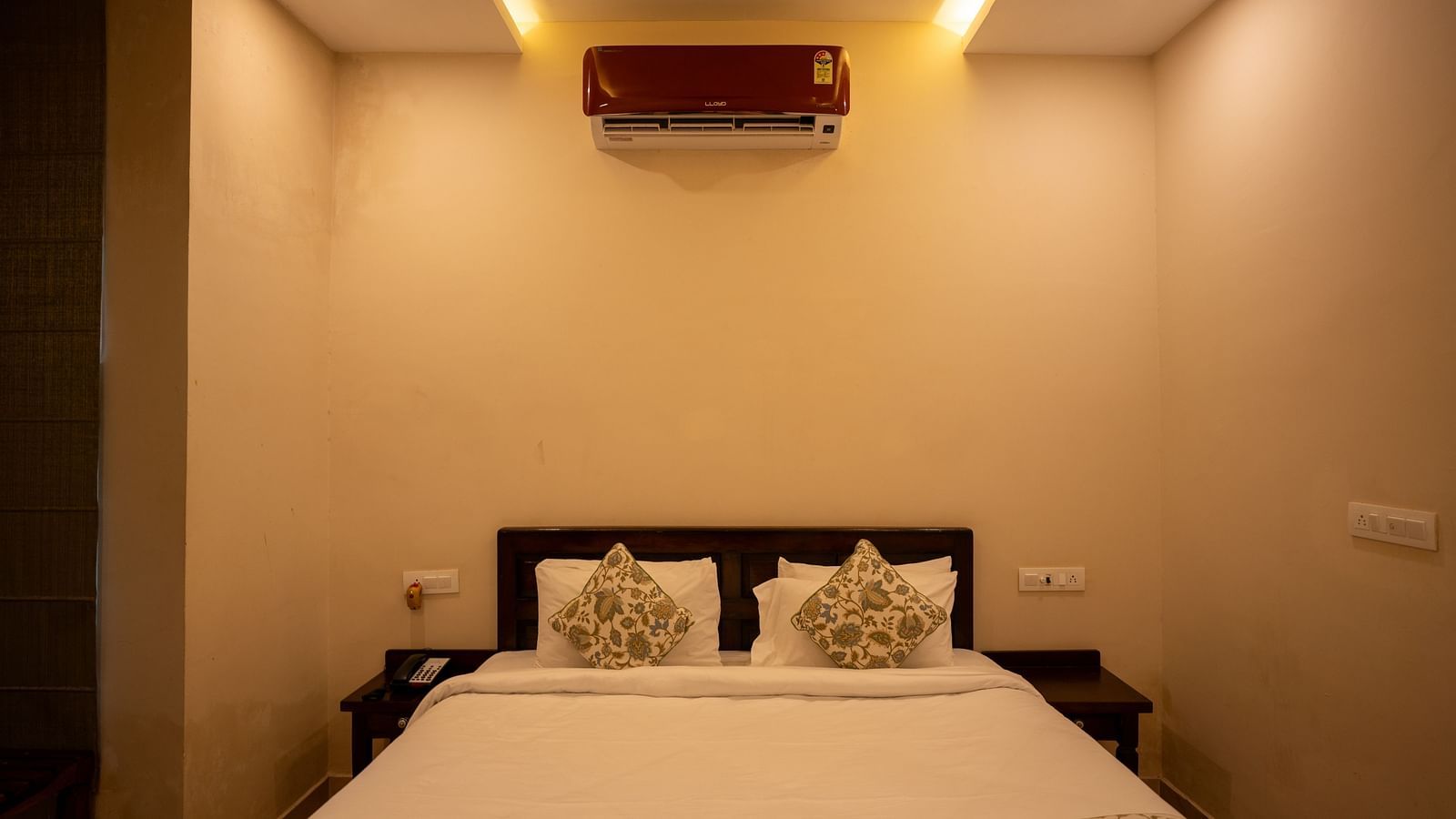 Room with bed and an air-conditioner above it at Aanandam Resort & Spa, Pushkar.