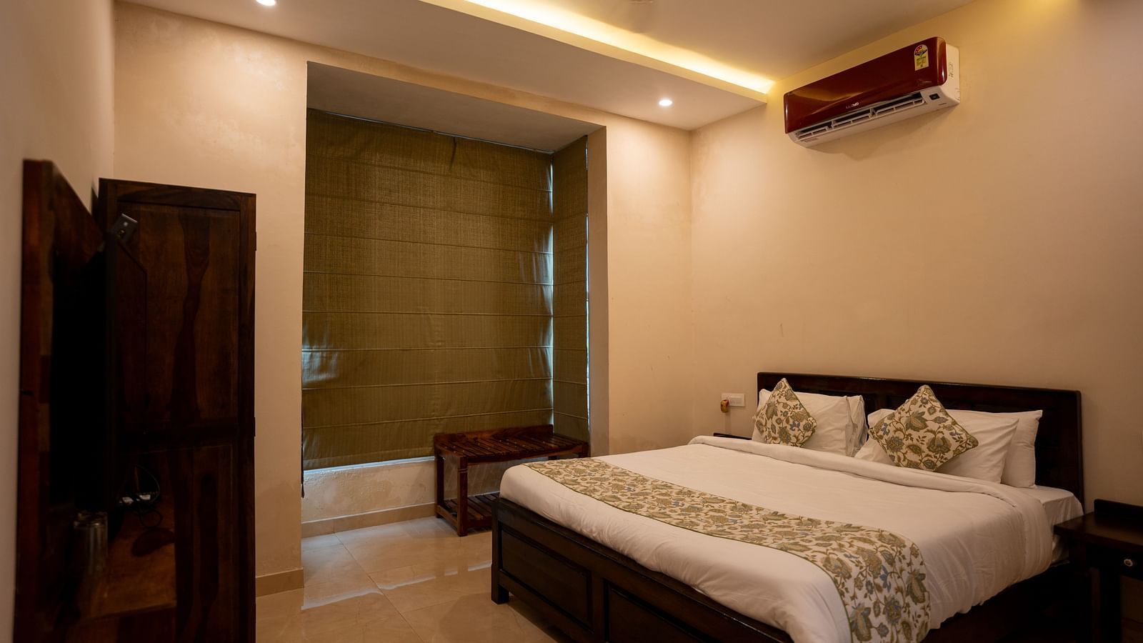 Image of a room with bed and a television in front of it at Aanandam Resort & Spa, Pushkar.