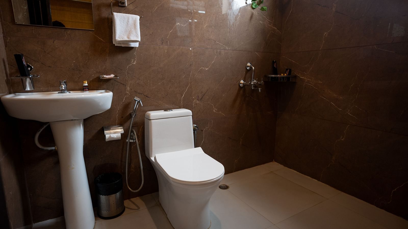 Image of a washroom with toilet and sink at Aanandam Resort & Spa, Pushkar.