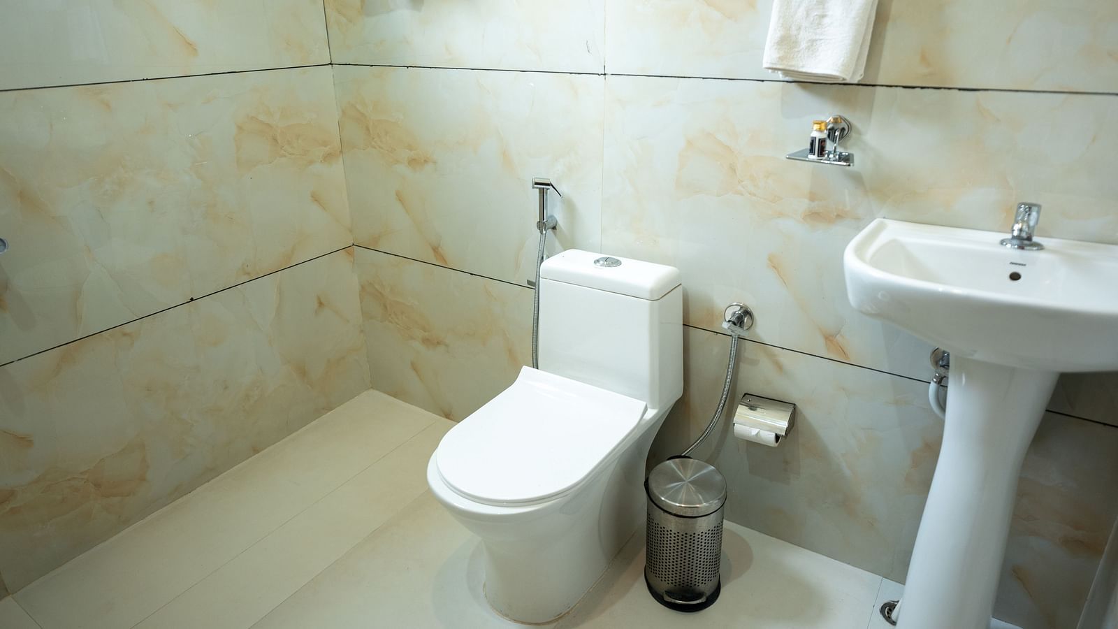 Image of a washroom with a sink and toilet at Aanandam Resort & Spa, Pushkar.