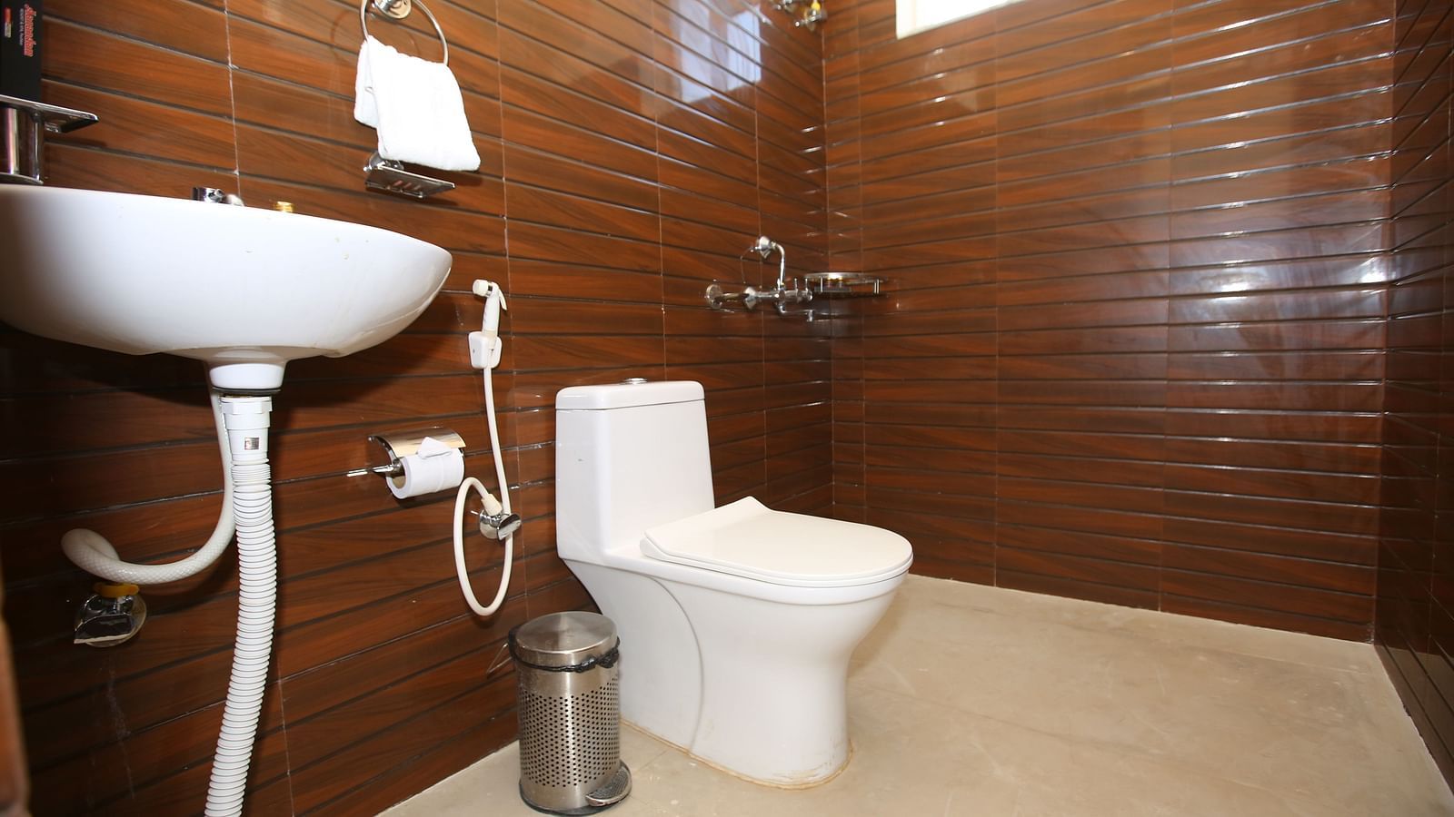 Studio Villa washroom featuring a sleek sink and convenient amenities, including a toilet paper holder, at Aanandam Resort & Spa