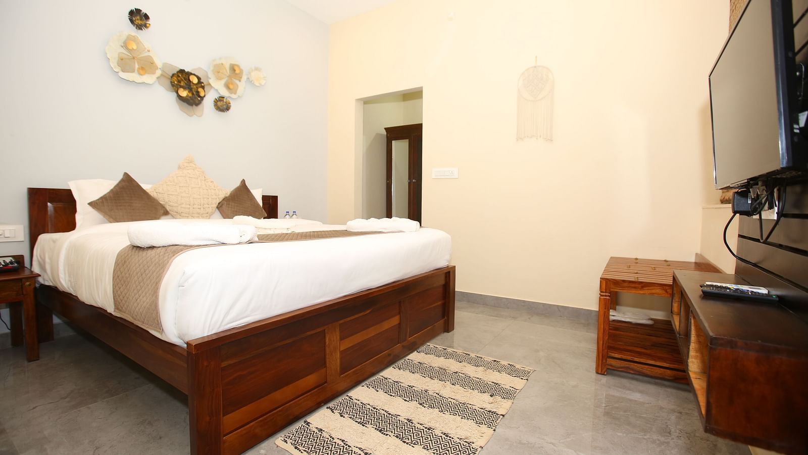 Studio Villa room with a spacious king-sized bed and a wall-mounted TV at Aanandam Resort & Spa