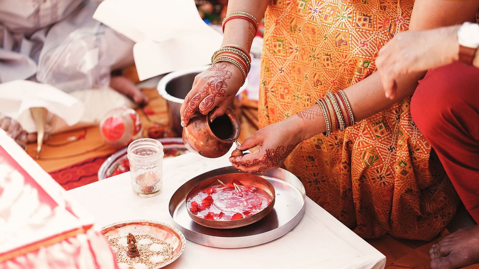 An image capturing a close-up of an Indian wedding ritual.