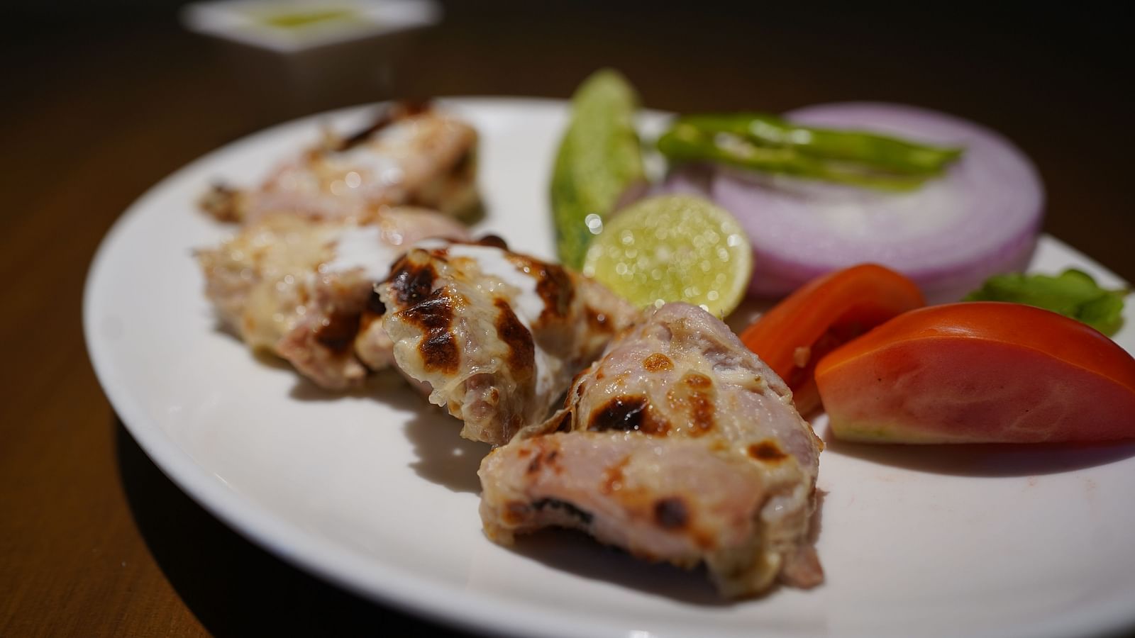 An image of appetisers dressed with onions and lemon - Argo By Trance, Goa