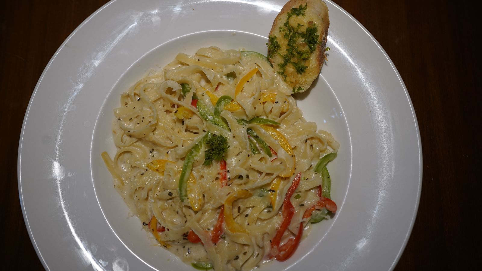 An image of a white sauce pasta placed on a table - Argo By Trance, Goa