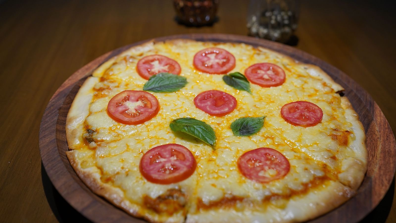 An image of a pizza placed at a table - Argo By Trance, Goa