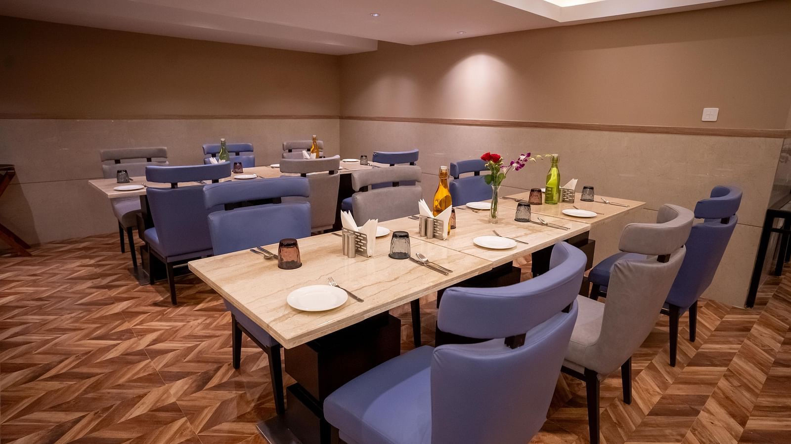 Nutmegg restaurant with neatly arranged tables and chairs at ASTER GRAND BY ZENQ SAKET.