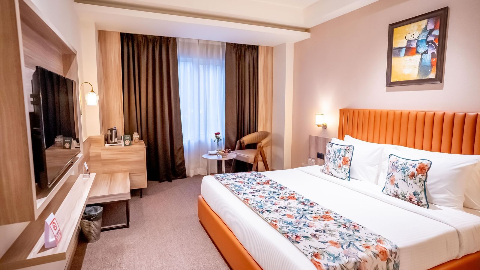 Superior Room at ASTER GRAND BY ZENQ SAKET with a bed, bed side table, TV, a chair and a window with curtain in the background.