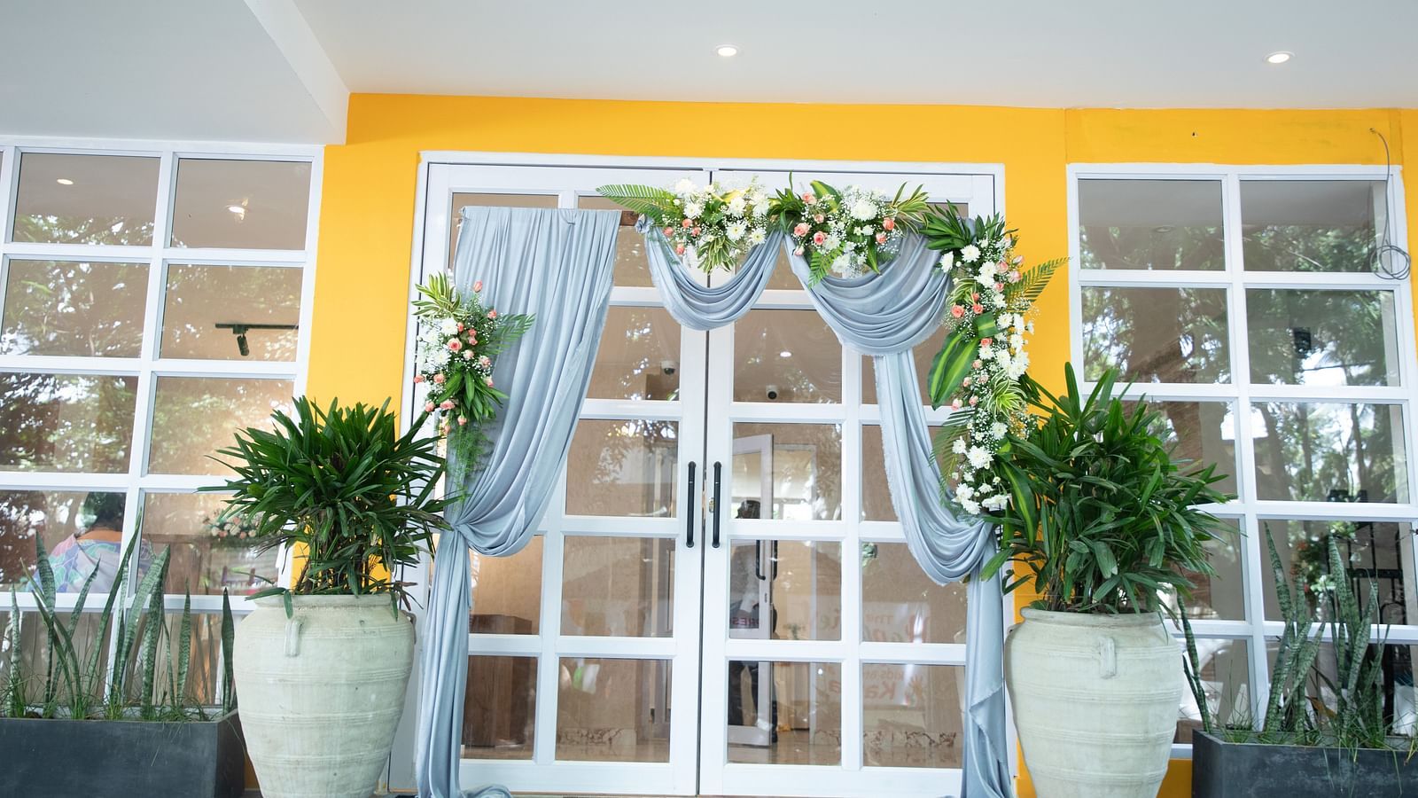 the entrace of Astra Hotels and Suites in Koramangala decorated with drapes and flowers