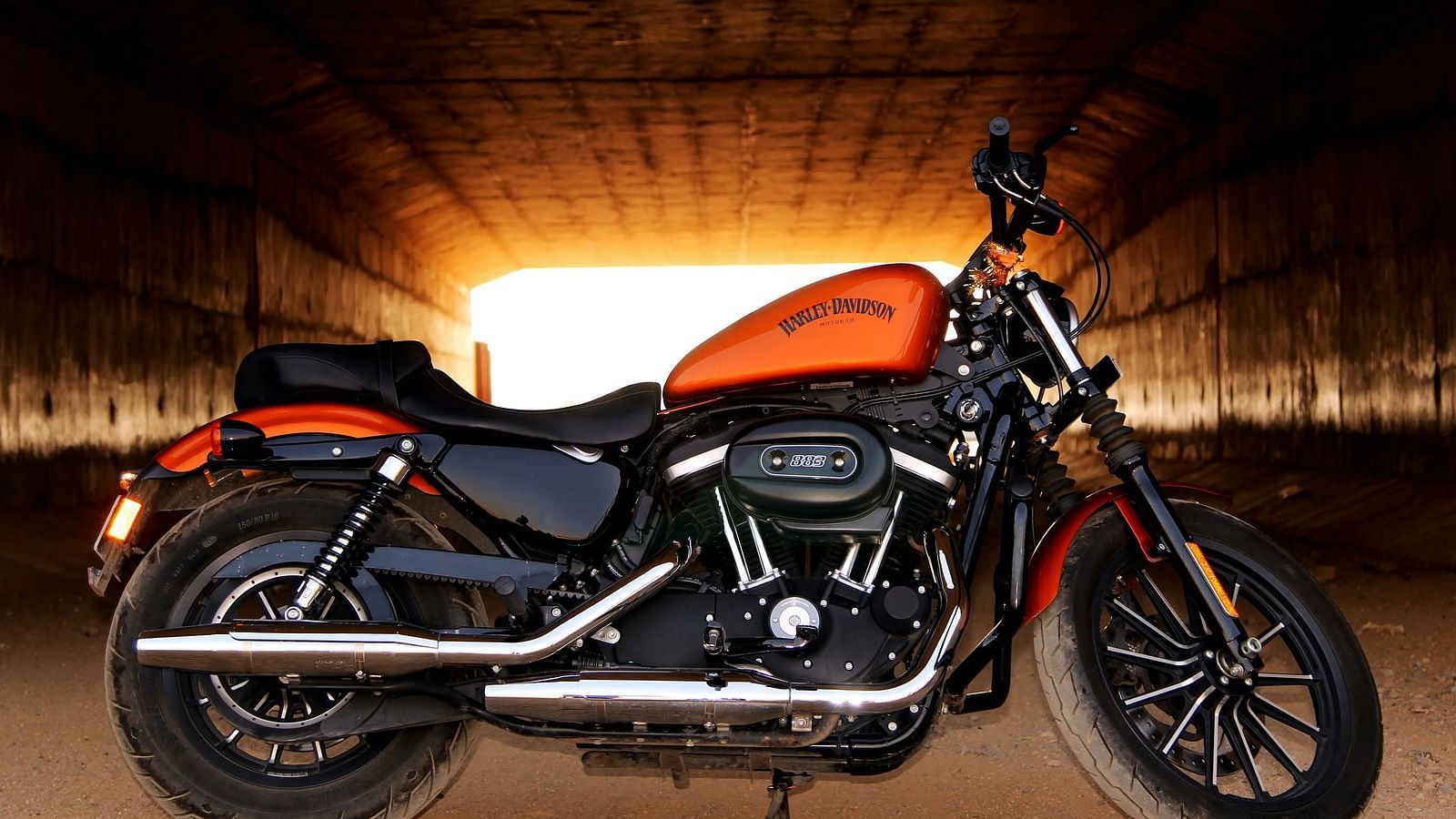 A motorcycle is parked in a tunnel-like space.