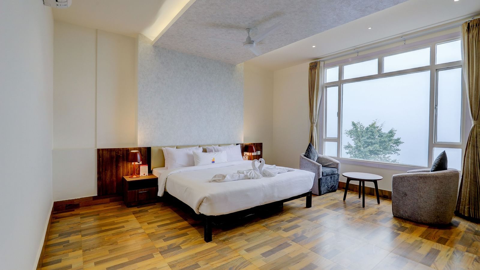 view of a king size bed of a Suite at Banari Regency by Summit, Namchi