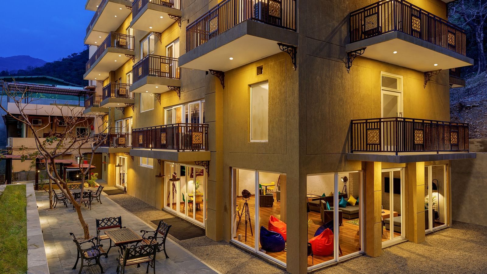 Exterior of the property with dining arrangements on the ground - Bedzzz, Rishikesh