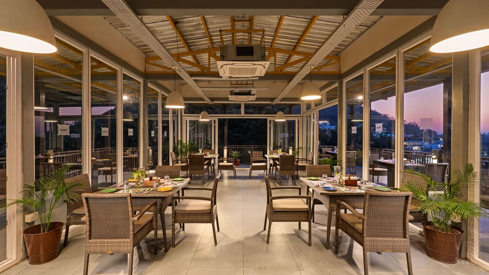 Dining area with air conditioner, featuring elegant decor and ambient lighting at Bedzzz, Rishikesh