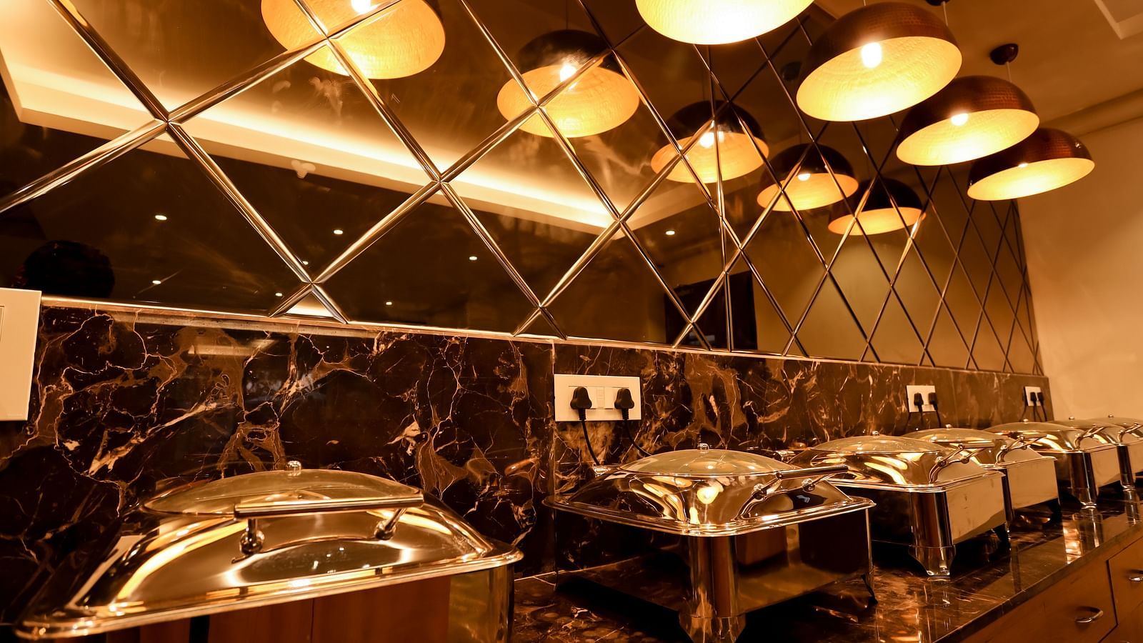 Image of a buffet table with food containers placed on it at Calux Grand Baga.