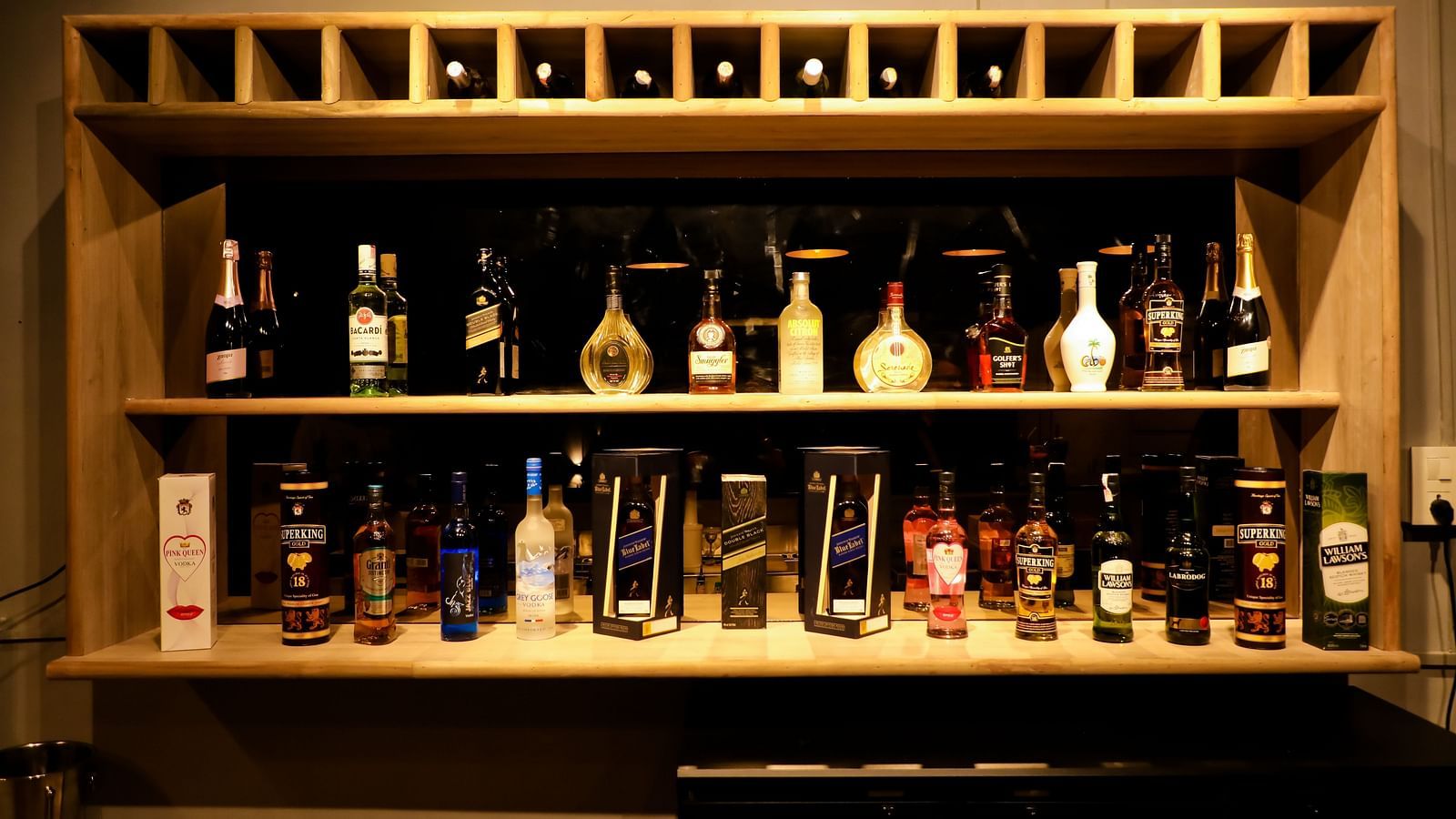 Image of a shelf with drinks arranged in it at Calux Grand Baga.