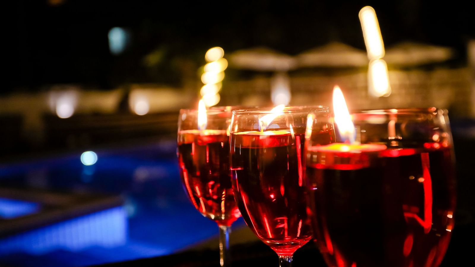 Image of three glasses of drinks with a blurred backround of a swimming pool at Calux Grand Baga.