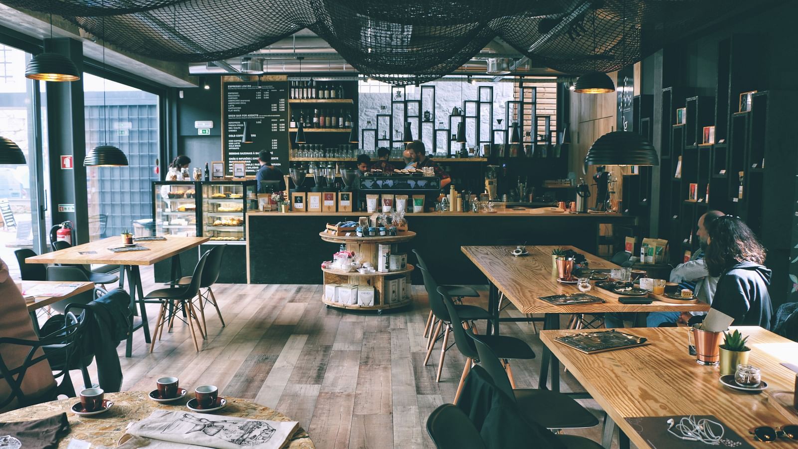 interior of a cafe with tables and chairs inside it