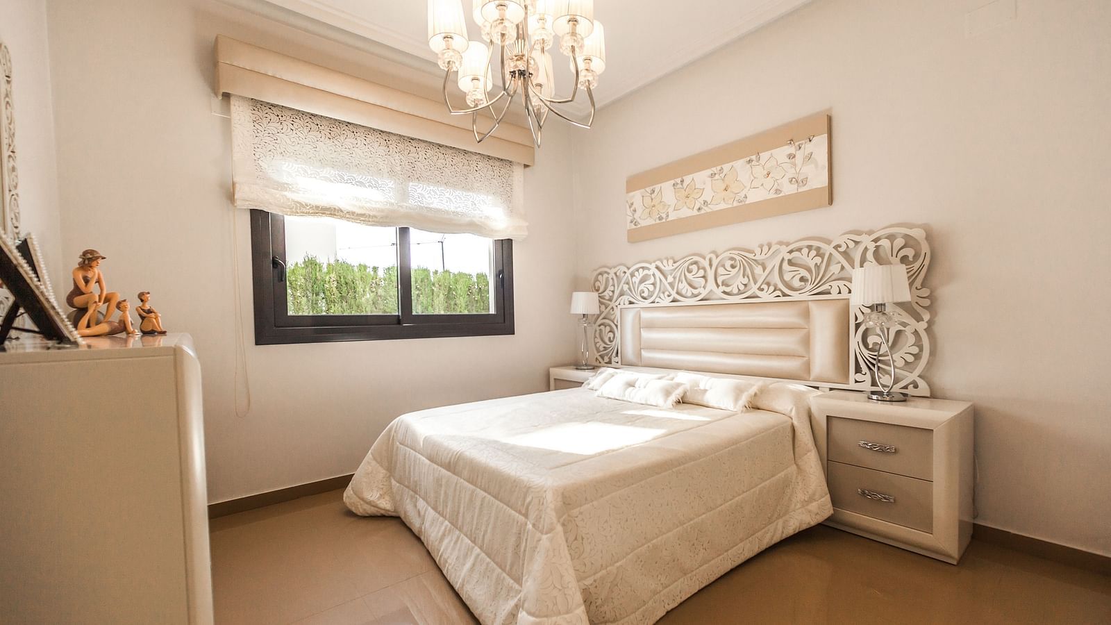 Regal bedroom with a side table beside the bed inside one of the rooms - Caravela Beach Resort Goa.