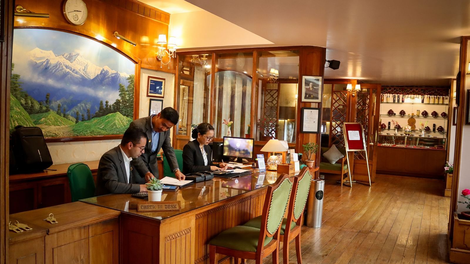 Front desk with staff assisting guests at Cedar Inn