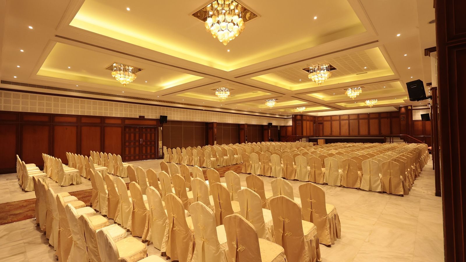 A diagonal view of the banquet hall from behind, with decorated chairs | Cenneys Gateway