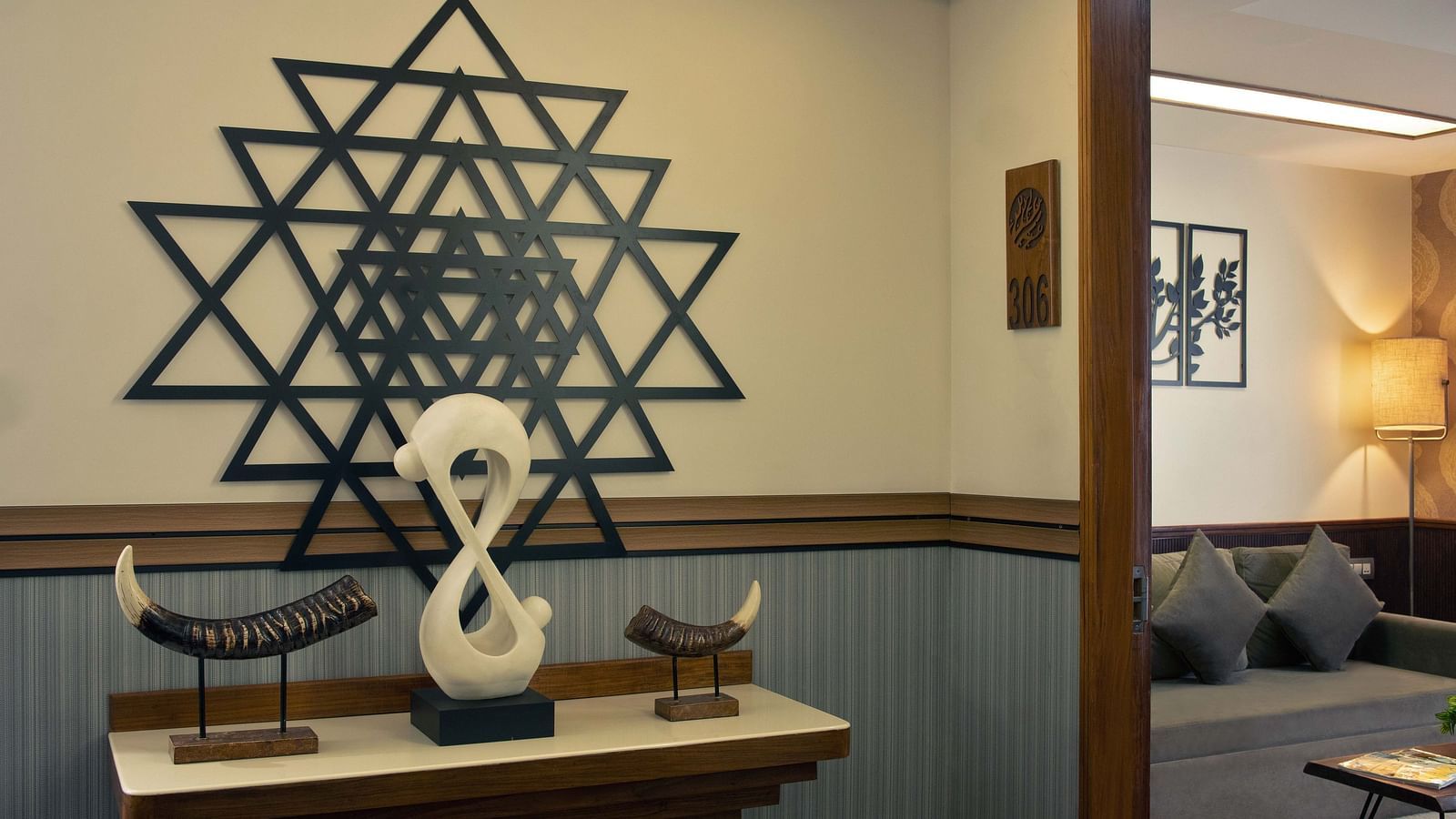 Image of a large vedic mandala placed on the table console along with various showpieces next to the waiting area at Coral Reef Hotel and Spa in Port Blair