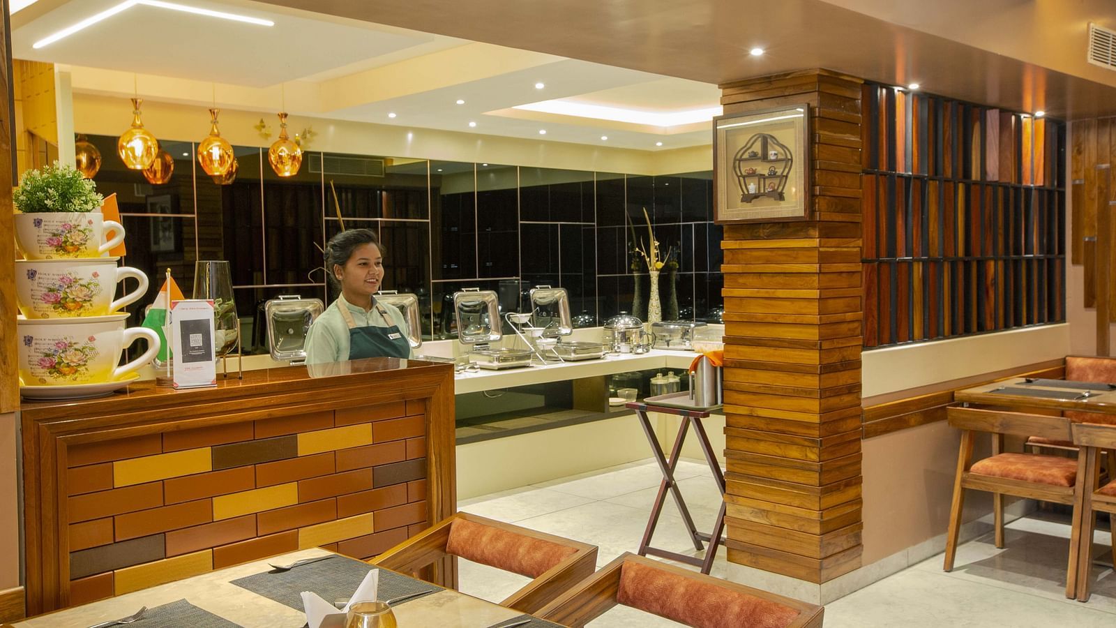 Image of a restaurant staff standing at the Honeycomb Restaurant at Coral Reef Hotel & Spa in Port Blair