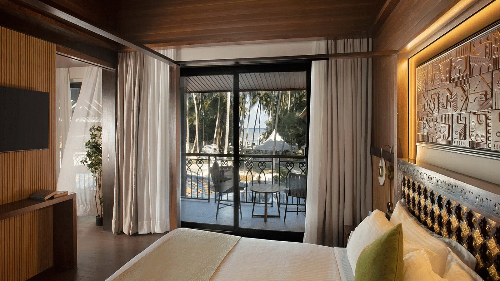 Image of the doorway to the balcony taken from the plush bed in Coral Teal Suite at Coral Reef Resort and Spa in Havelock