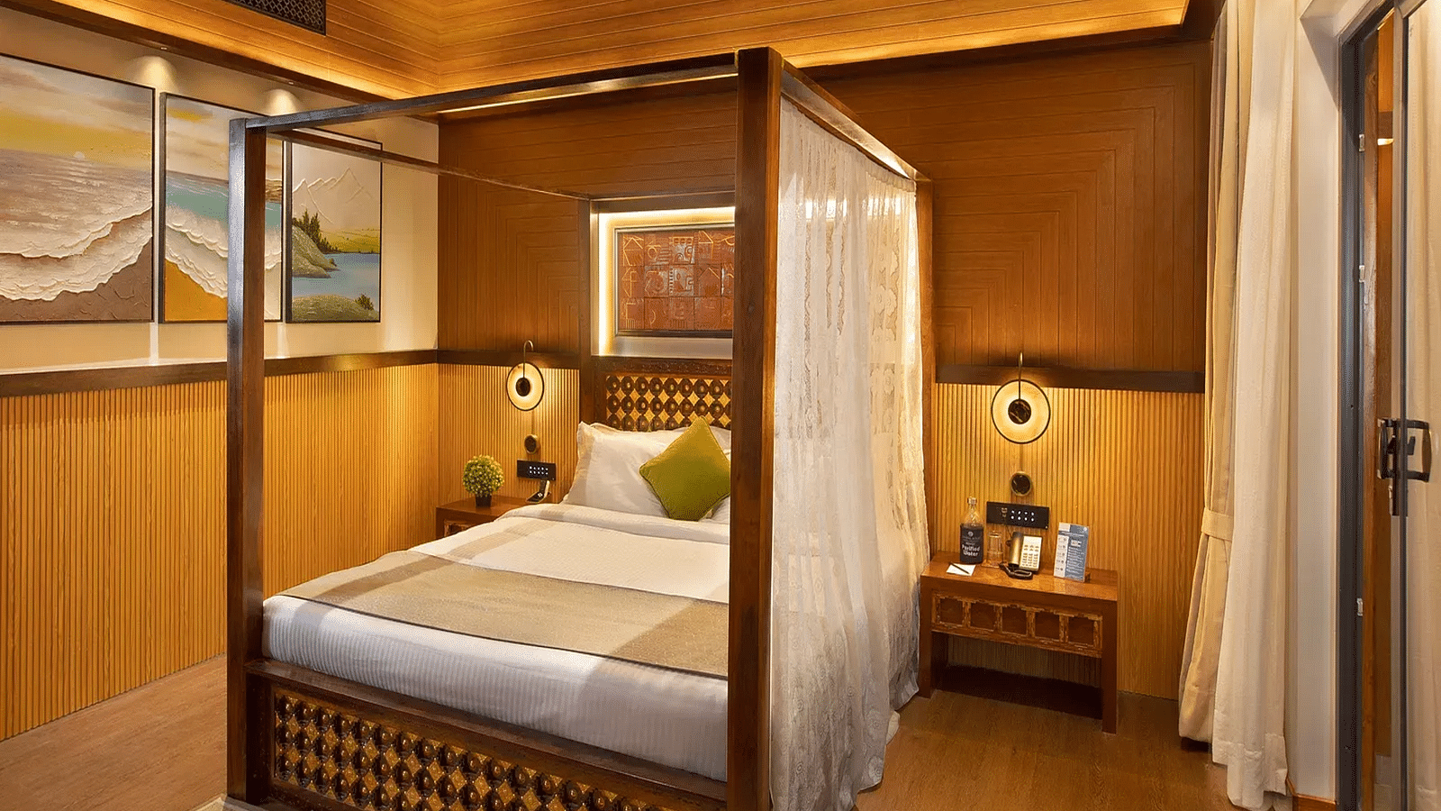 Coral Teal Suite at Coral Reef Resort and Spa in Havelock featuring a plush canopy bed with a nightstand next to it and a lamp over it