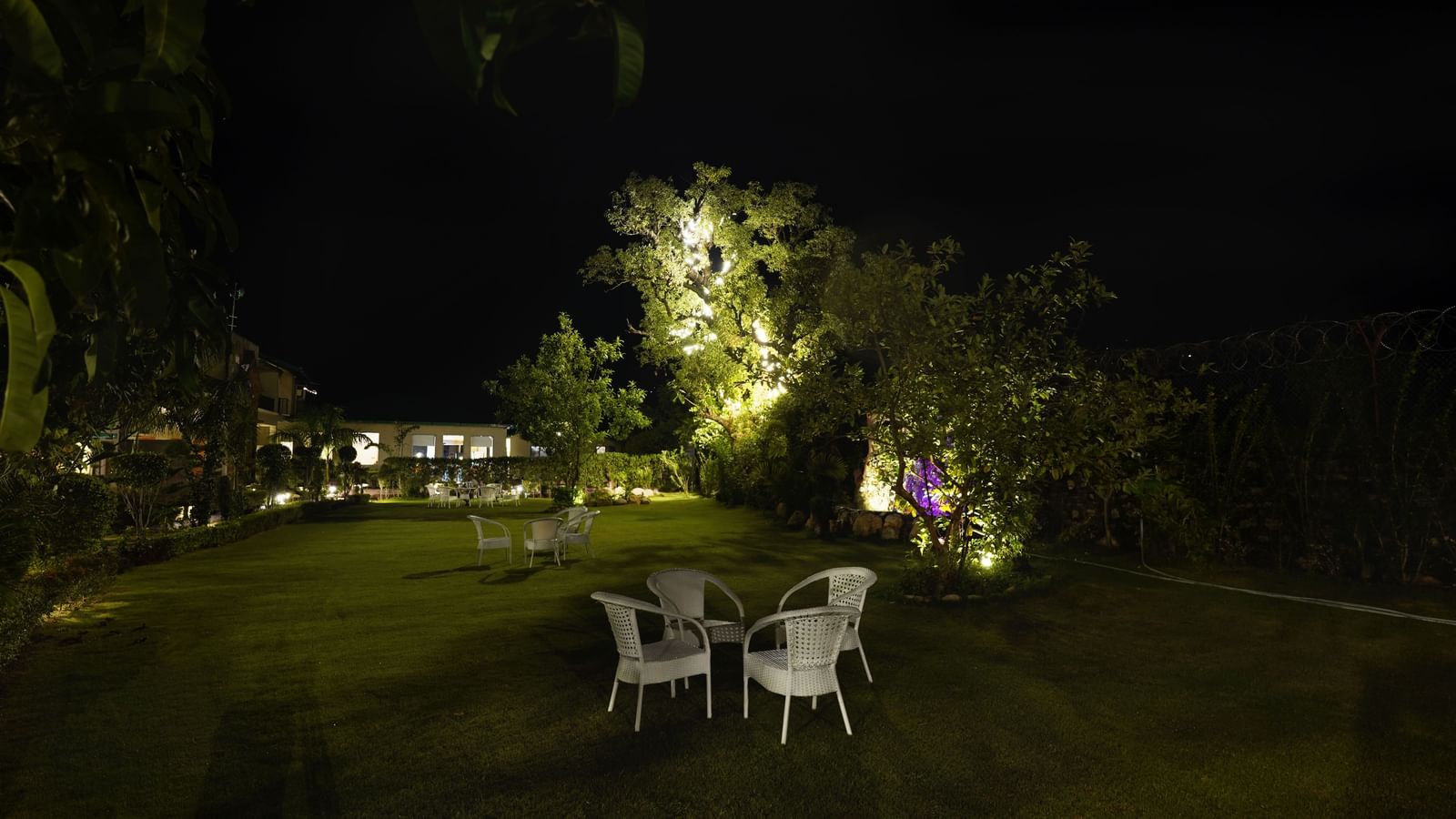 Full view shot of the Lawn 2 during the night time dimly-lit with exterior lights at Corbett Nirvana Resort.