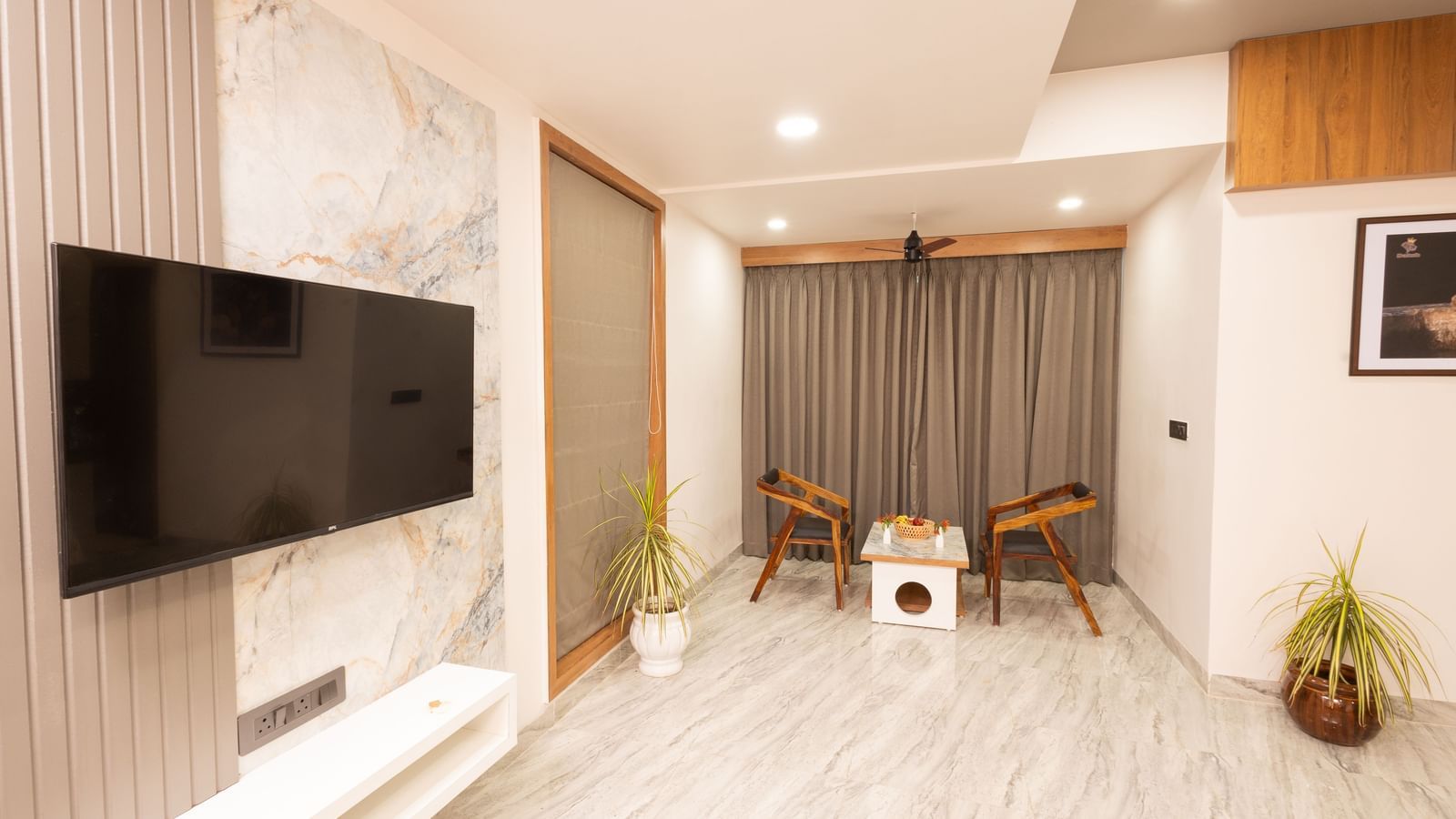 Wide view of the living area in the Daksh Bliss room at Daksh Eden Greenz.