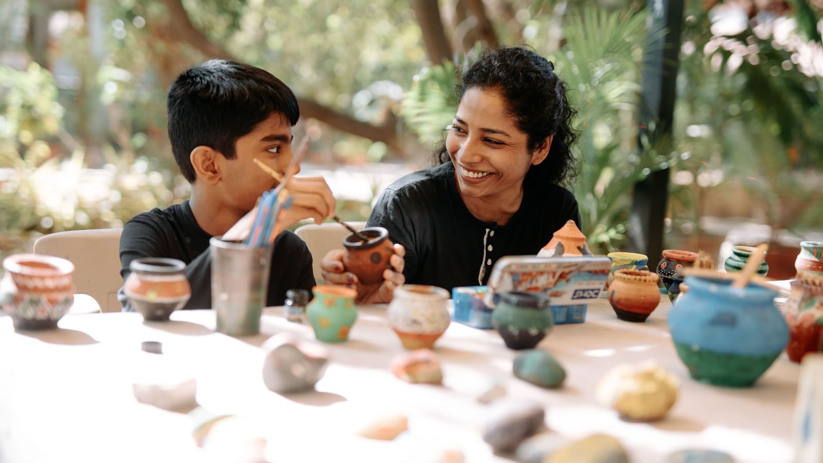 A lady and a young kid participating in art & craft session at Daksh Resort & Amusement Park.