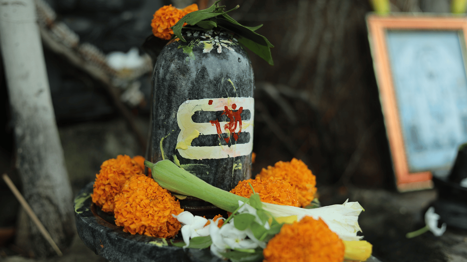 flower offerings kept in front of a lingam
