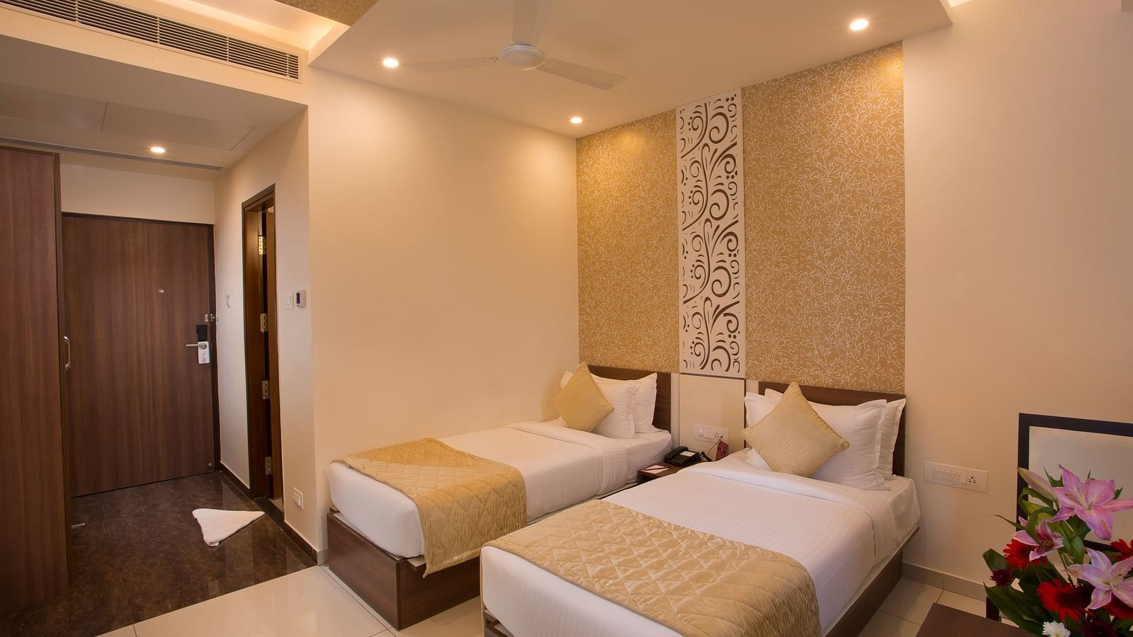 A hotel room with two single beds, patterned wallpaper and a warm, inviting decor - De Venetian by TGI, Brookefield