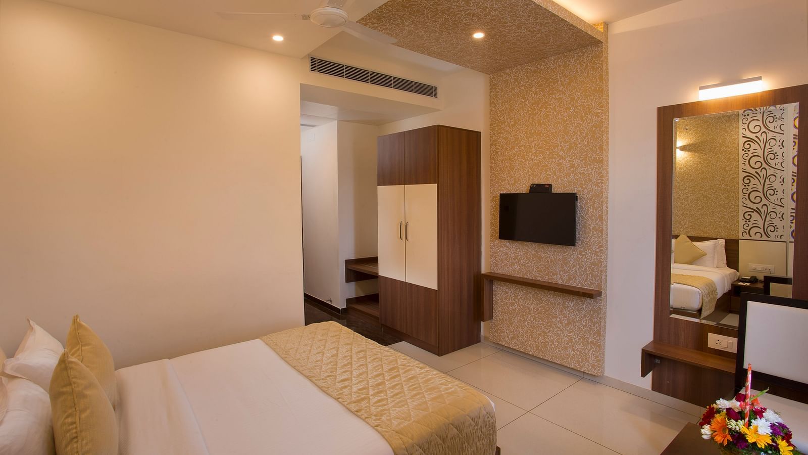 A cosy hotel bedroom with a large bed, decorative wallpaper and a giant mirror - De Venetian by TGI, Brookefield