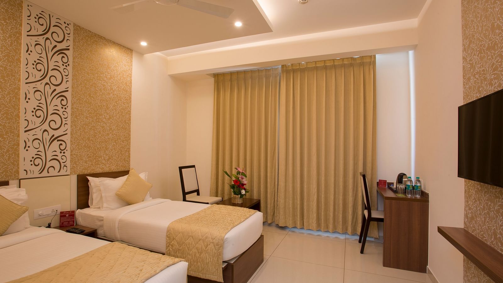 A spacious hotel room with modern amenities, twin beds and decorative wallpaper - De Venetian by TGI, Brookefield
