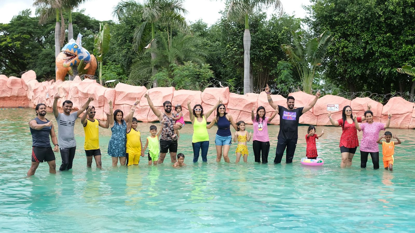 Group of friends posing joyfully in a shallow water pool at a theme park | Diamond Parks, Pune 