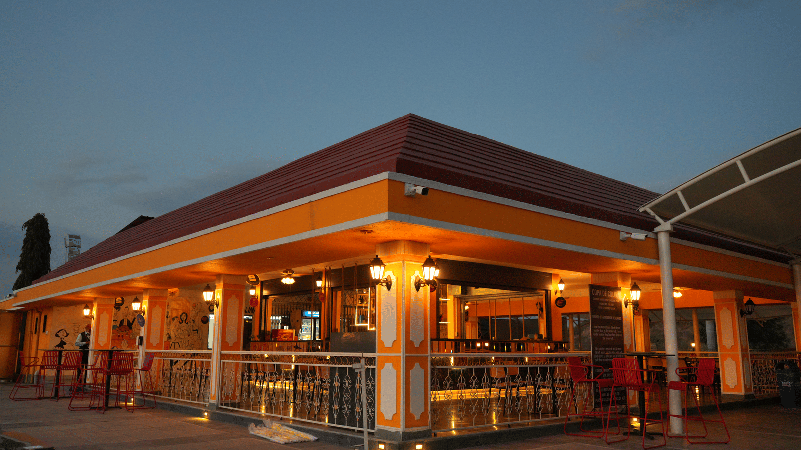 A facade view of the hotel Copa de Colina during twilight with the lights on, ideal for the perfect Photoshoot in Pune.