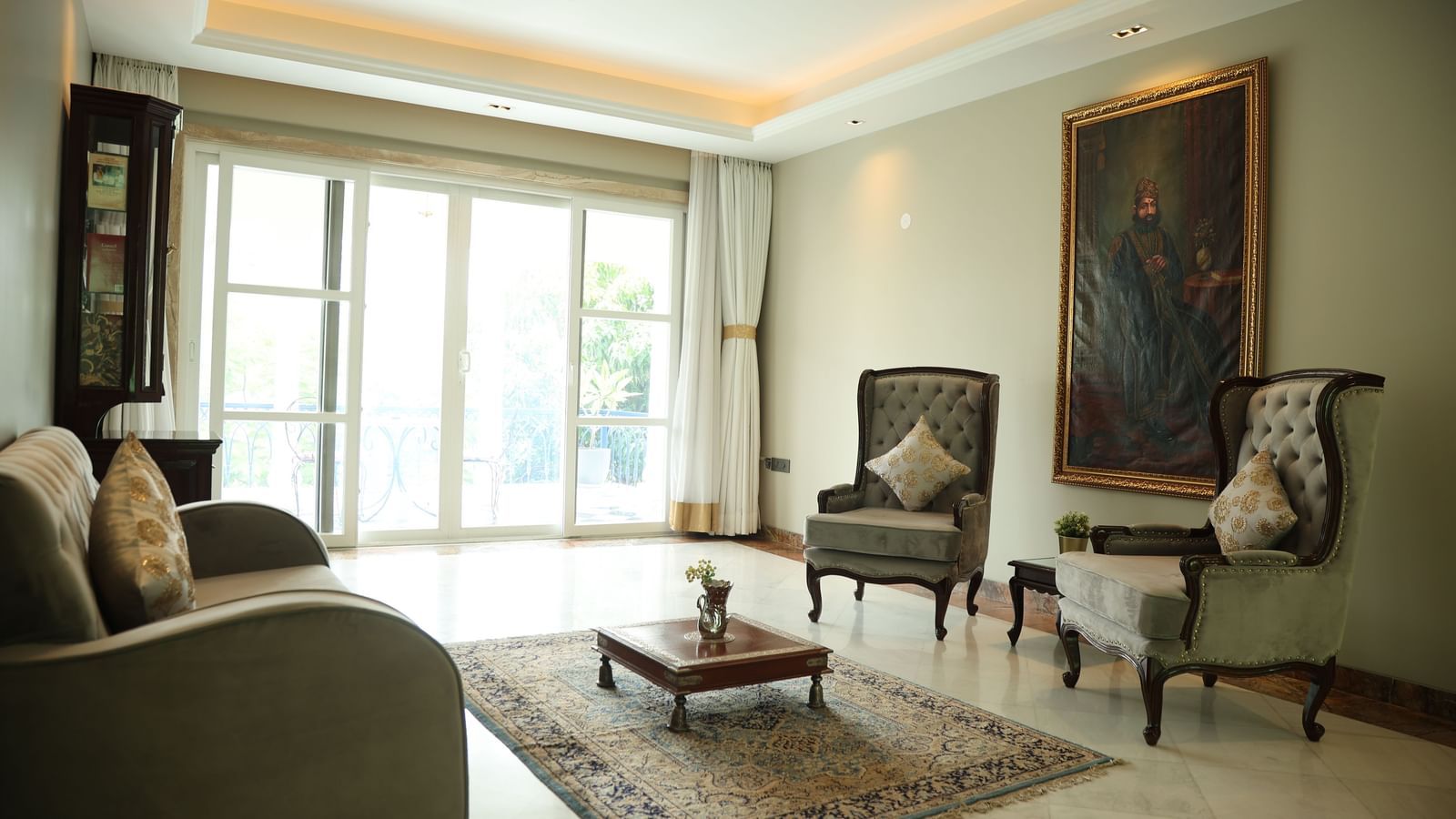 Library lounge at Dileep Kothi, Jaipur with sofa chairs and French windows