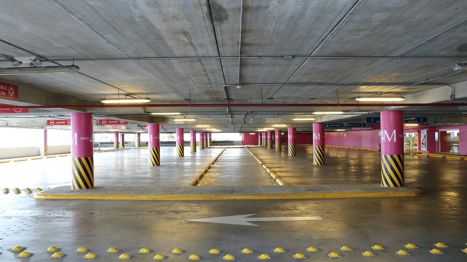 image of an empty parking lot with guiding arrows on the floor