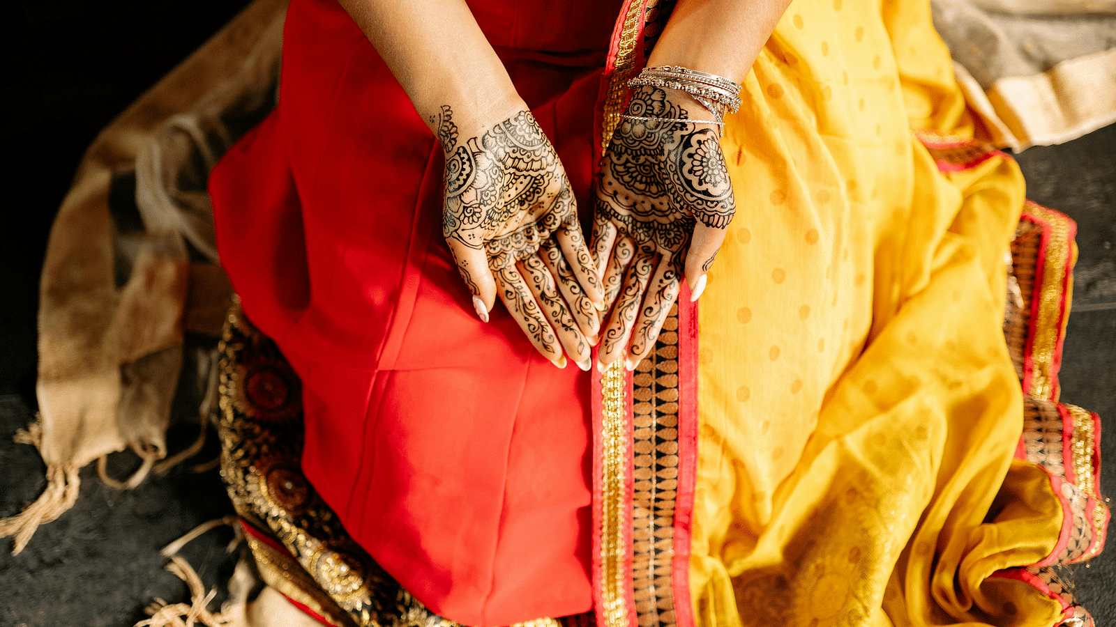 a woman with her palms open showing her mehendi on her hands