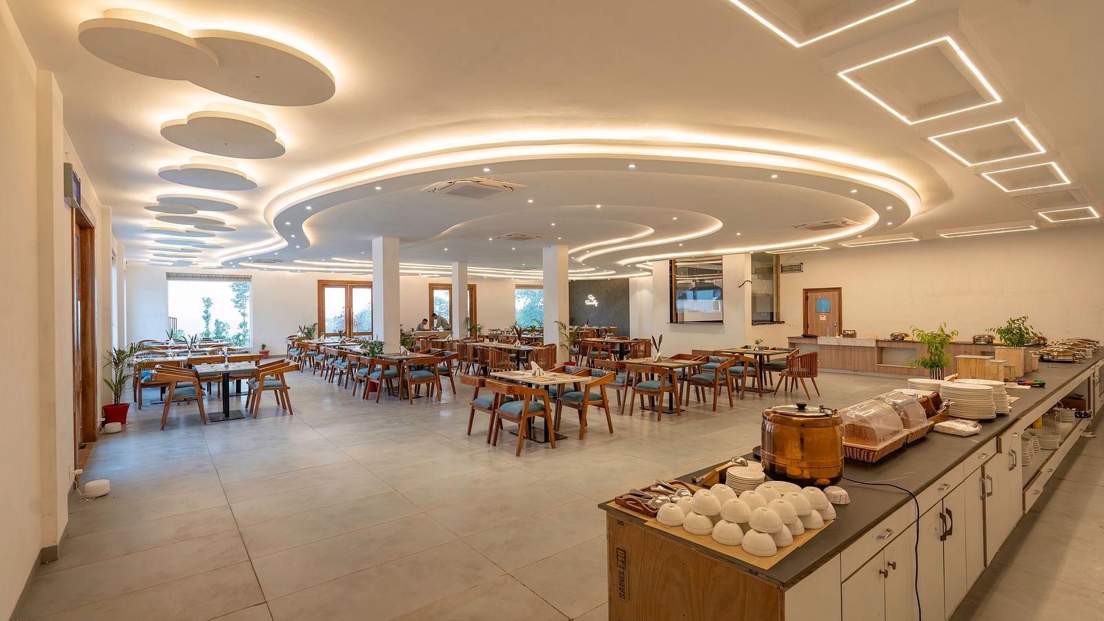 A dining room with a buffet table and seating arrangements.