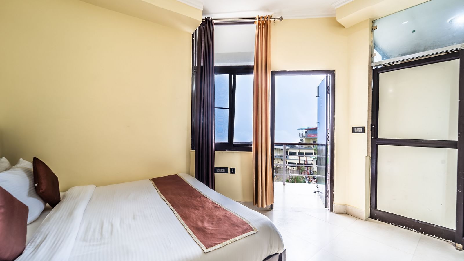 a room at Flutter Hotels & Resorts featuring a bed and a wardrobe