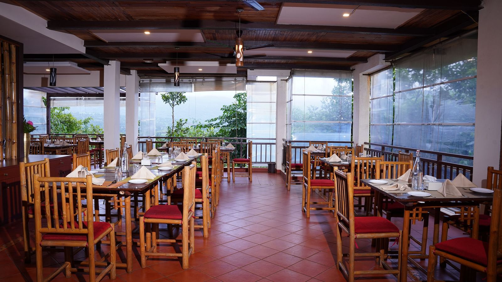 Another view of the dining space at Forest Escapes Koyna, showcasing the arrangement of tables and chairs.