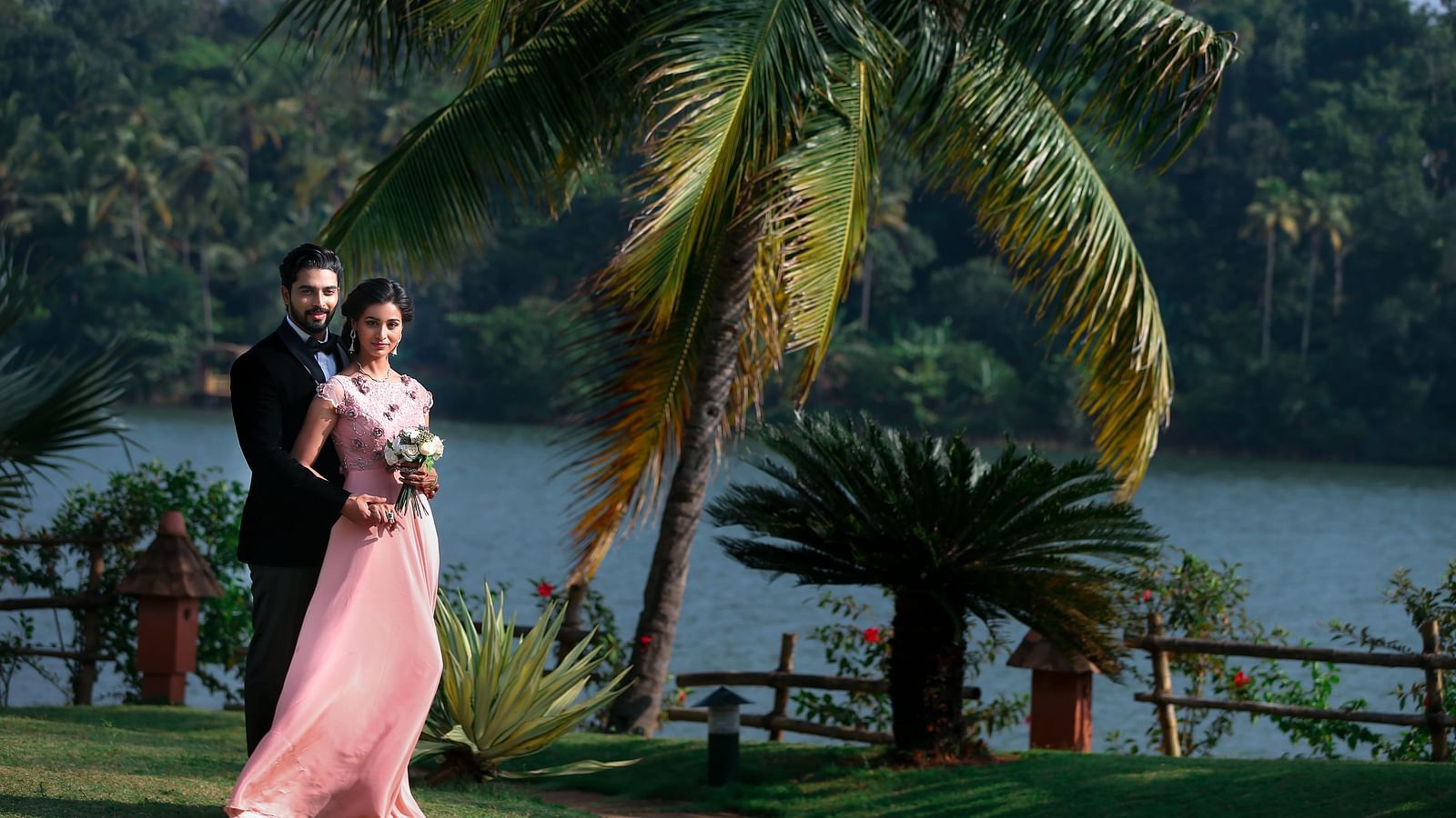 A wedding shoot of a couple is underway, set amidst nature-inspired decorations.