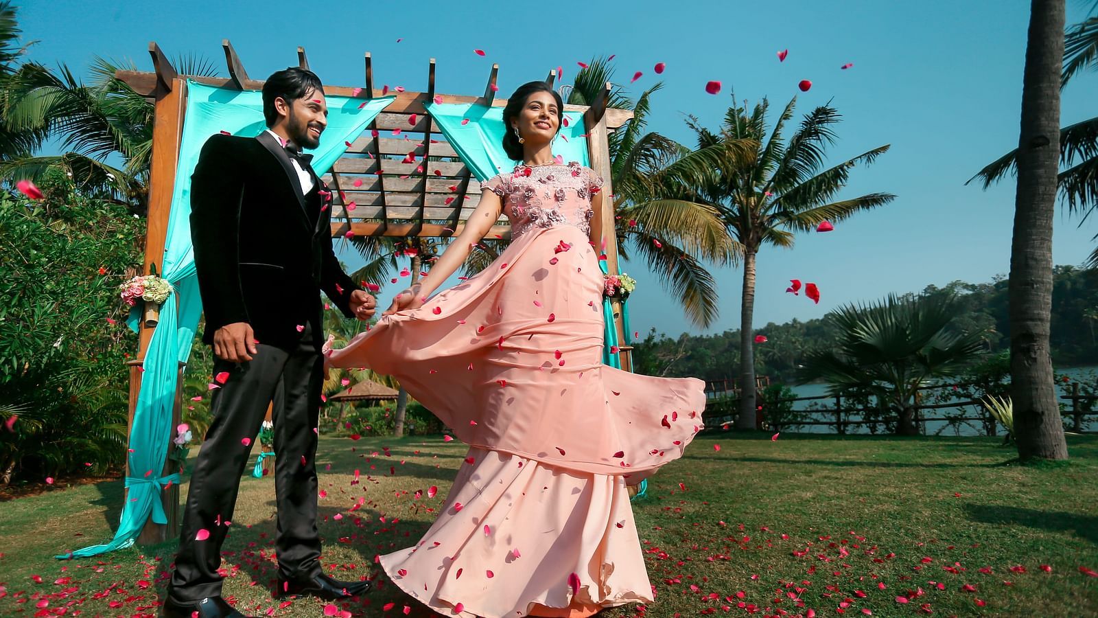 A wedding shoot of a couple is in progress, surrounded by nature-inspired decorations