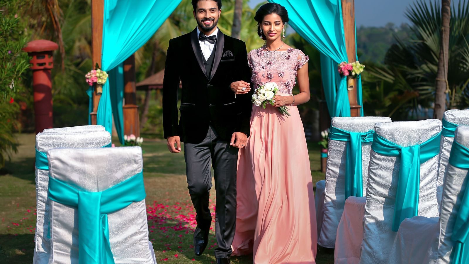 A couple’s wedding photoshoot as they walk down the aisle