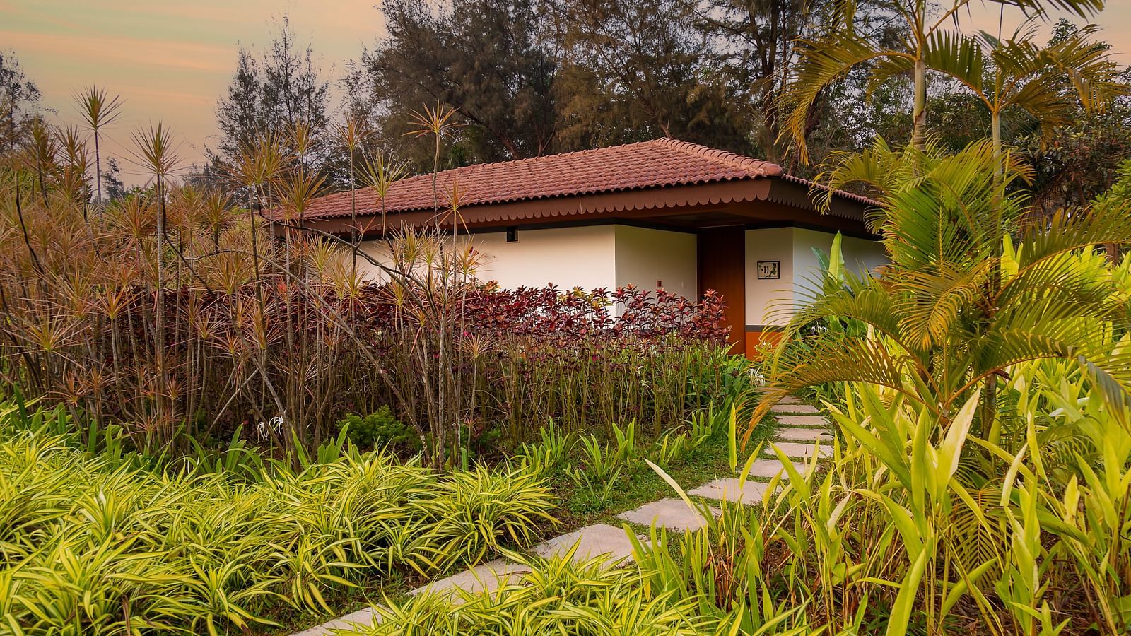 An far out view of the Villa with various trees and plants around it - Gamyam Retreat